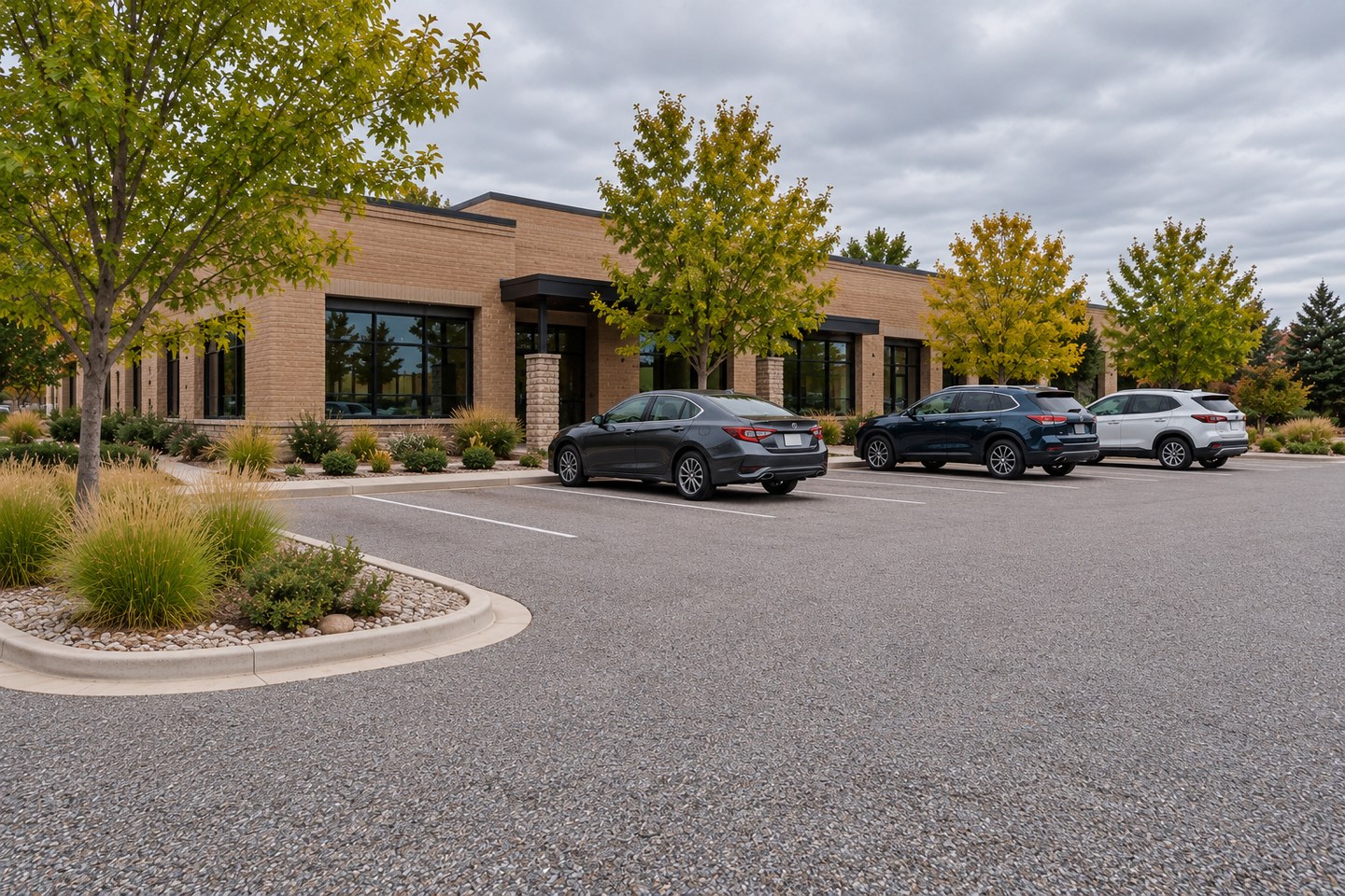 Design visualization of gray resin-bound commercial parking area with marked stalls in Fort Collins, alternate angle