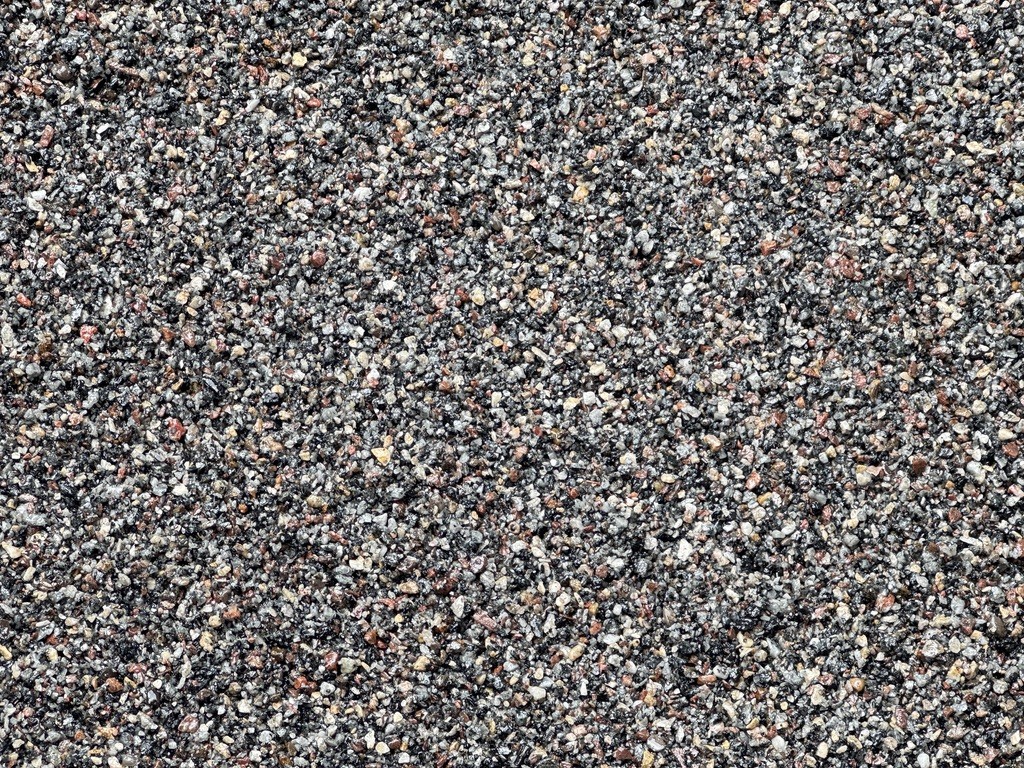 Close-up supplied photograph of mixed natural stone aggregate texture